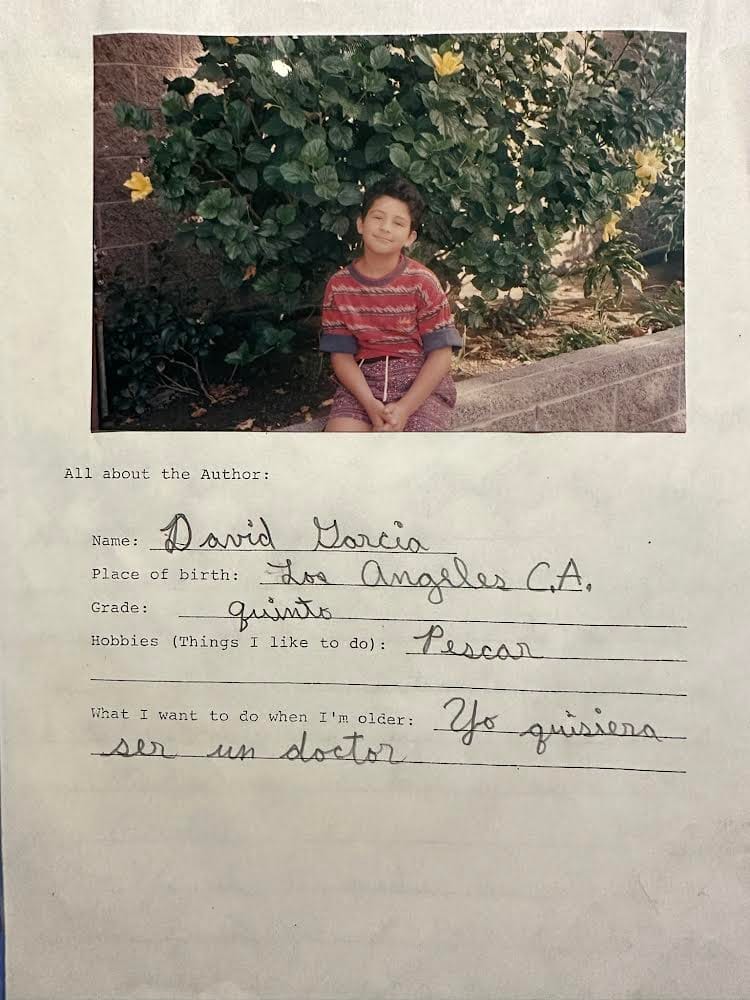 A form filled out by a young boy that also includes a picture of a boy sitting on a low stone wall.