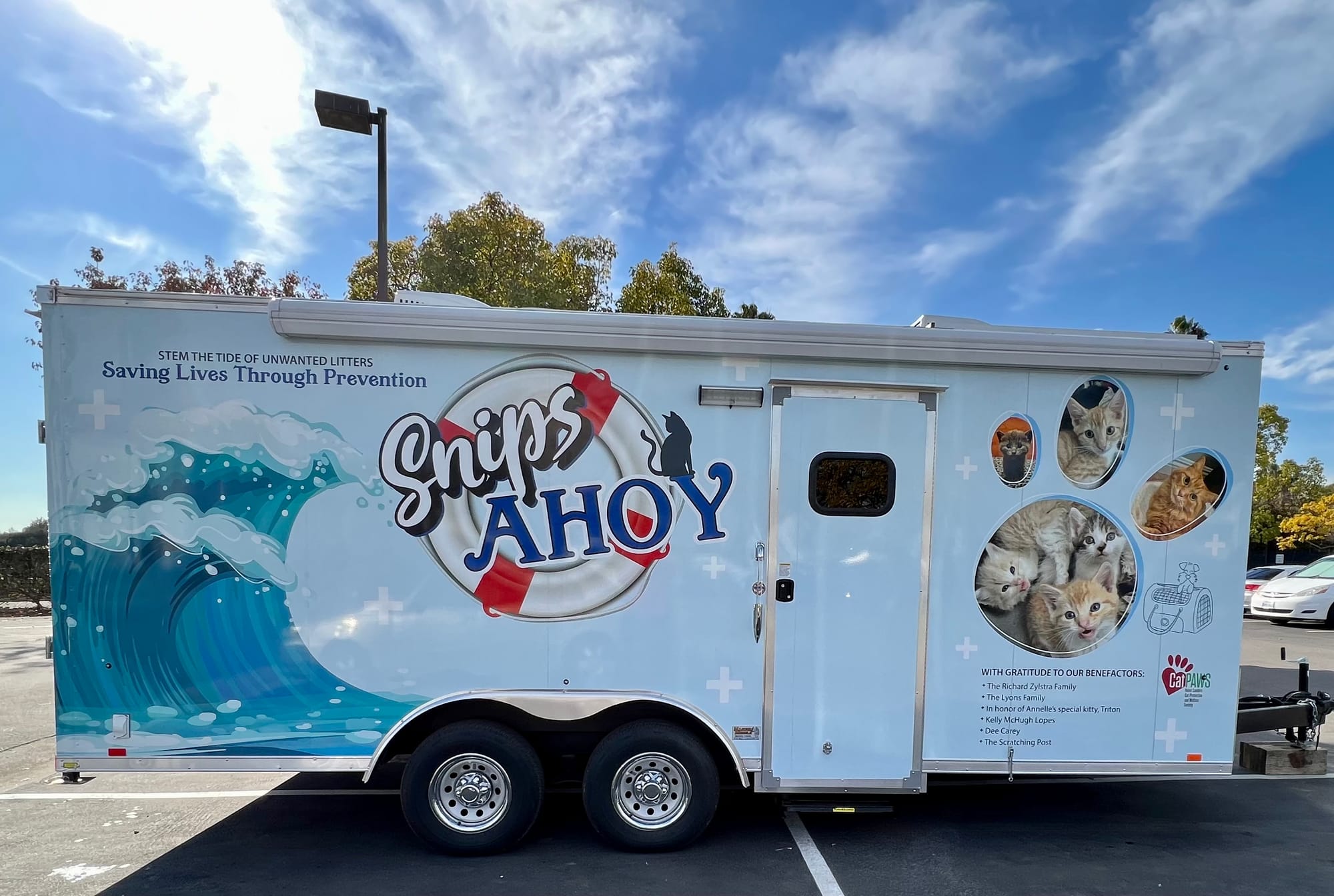 A white trailer with the words "Snips Ahoy" painted on the side.