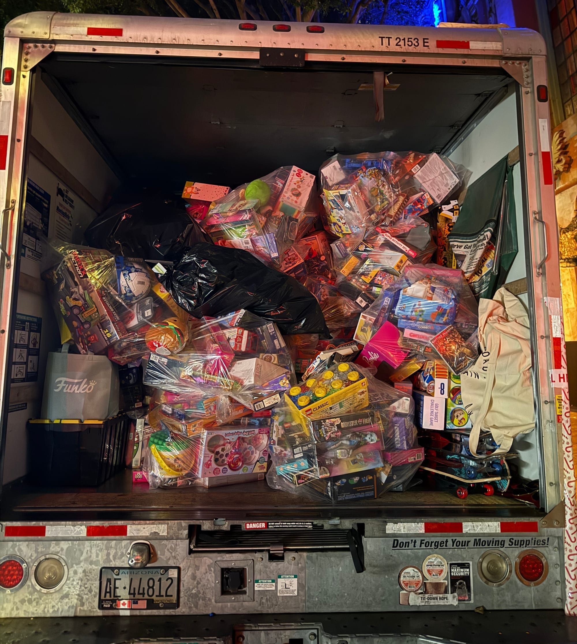 A large moving truck filled with bags of toys.