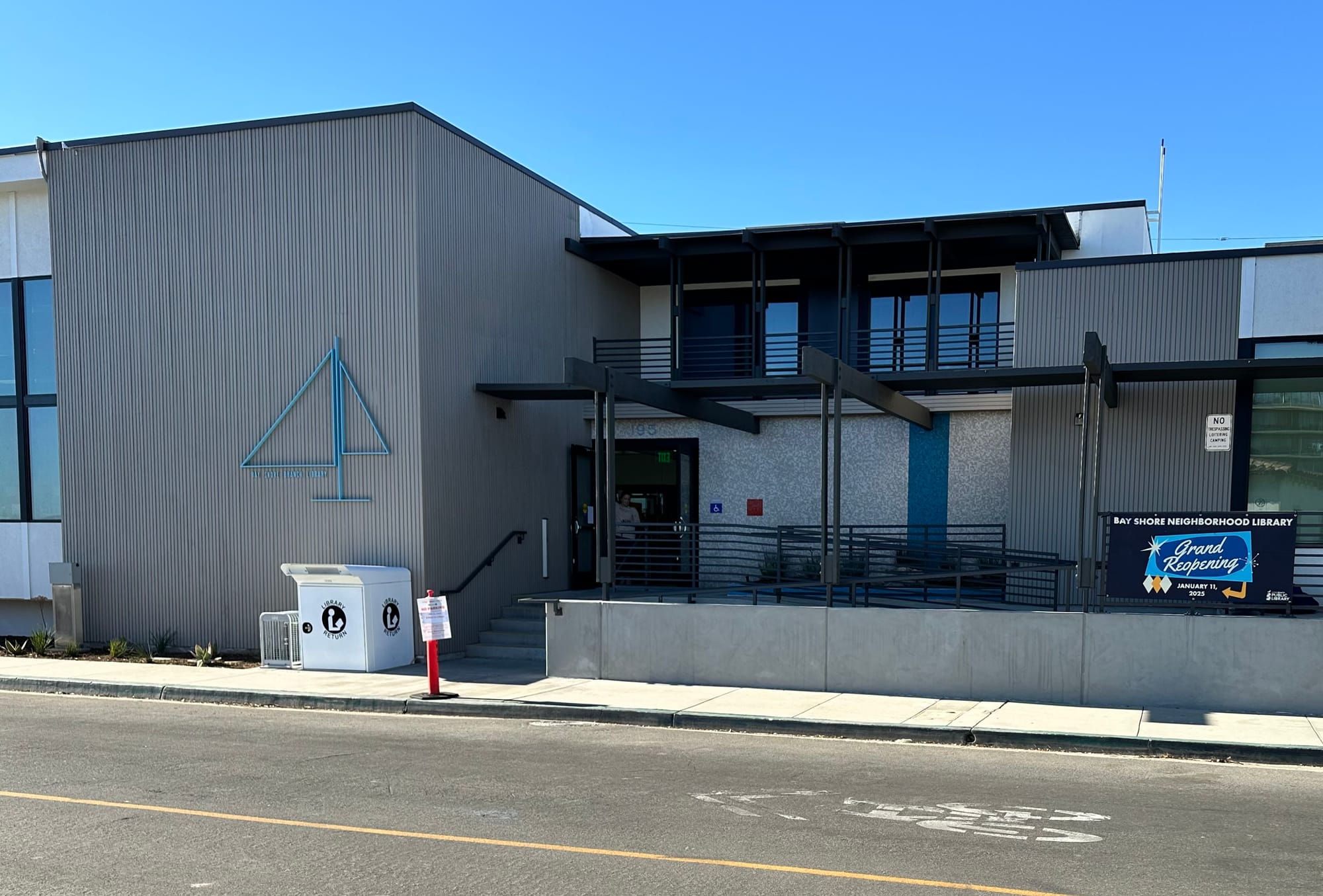 A gray and white building under a clear blue sky.