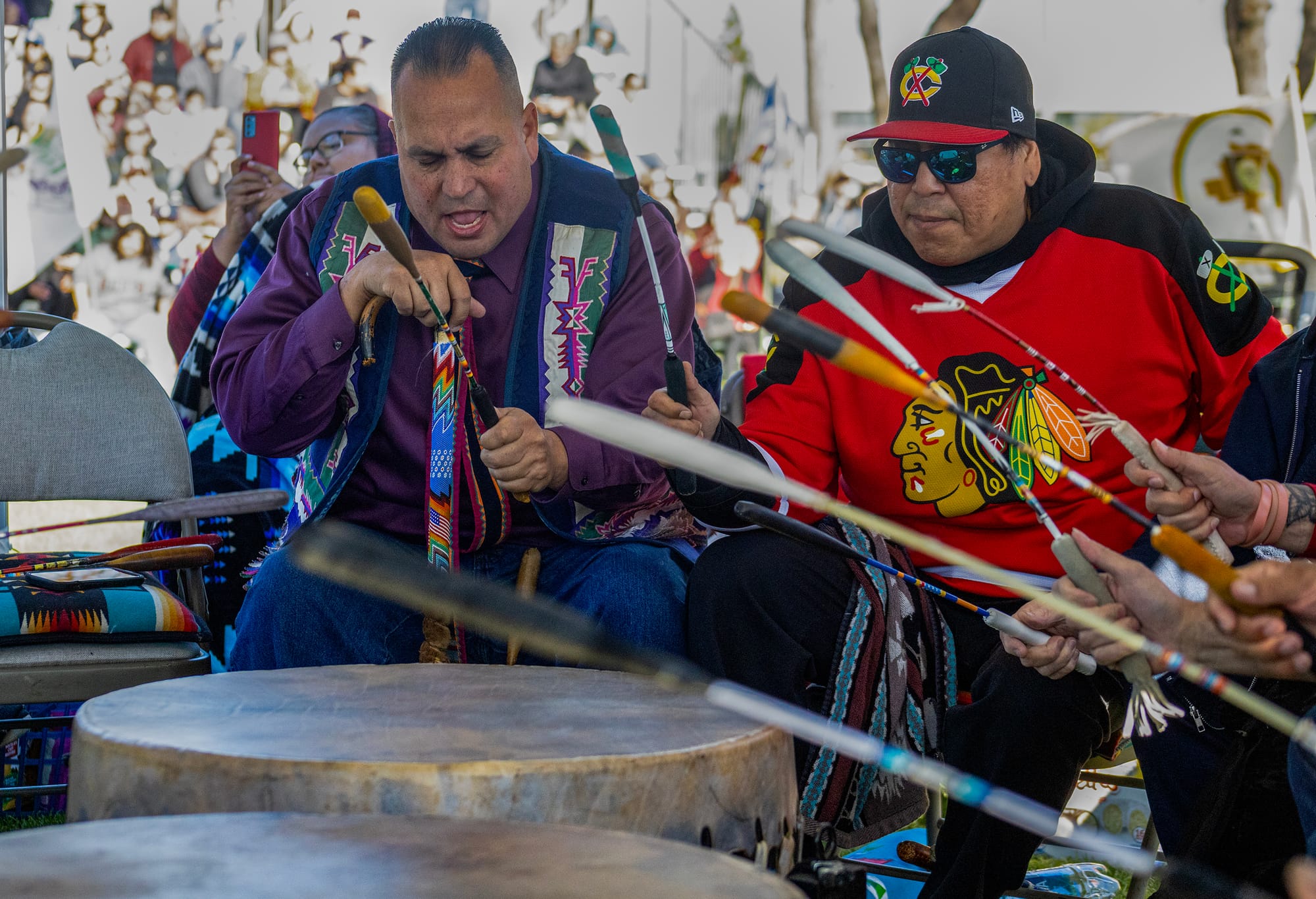 Two men play large drums.