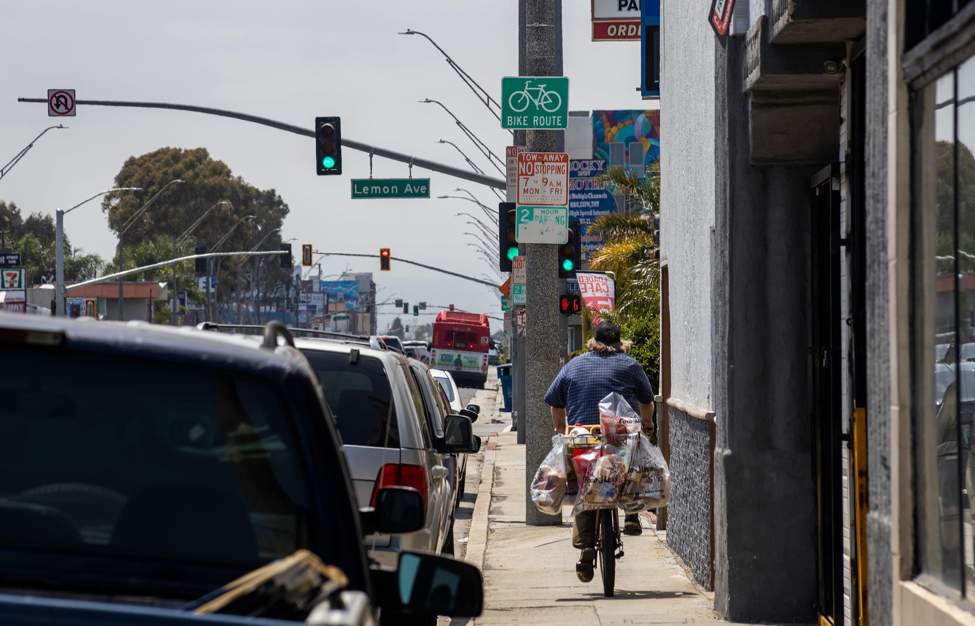 A person rides a bicycle on the sidewalk.