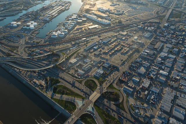 Aerial view of roads, fuel storage tanks, railroad tracks and port docks.