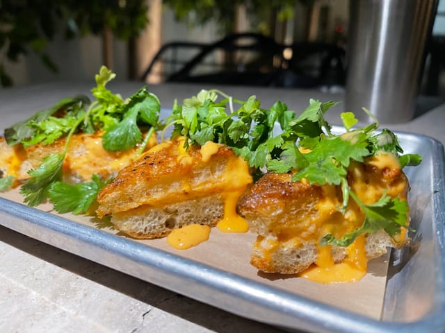 Shrimp toast on a metal pan.