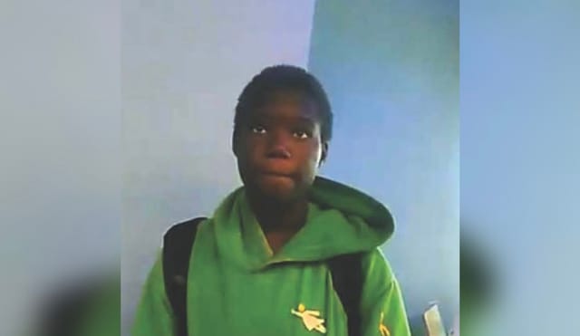 Teenager wearing a green hoodie.