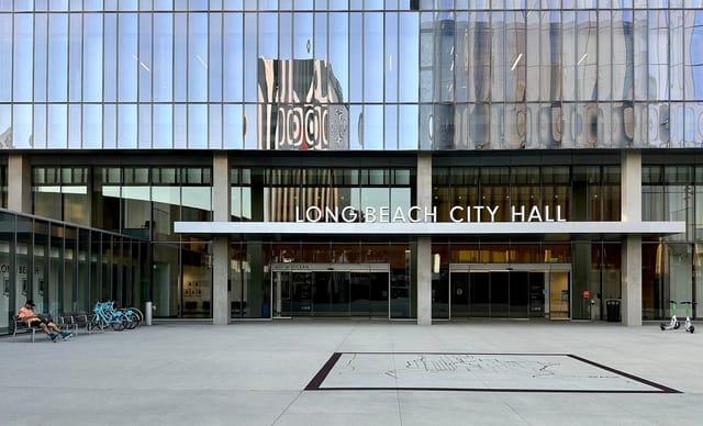 A glassy office building displaying the sign Long Beach City Hall.