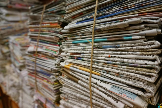 Stacks of bundled up newspapers.