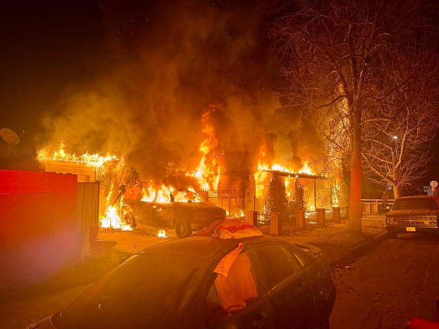 A house and car on fire.