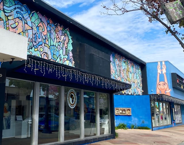 A building that’s painted with a variety of shades of blue.